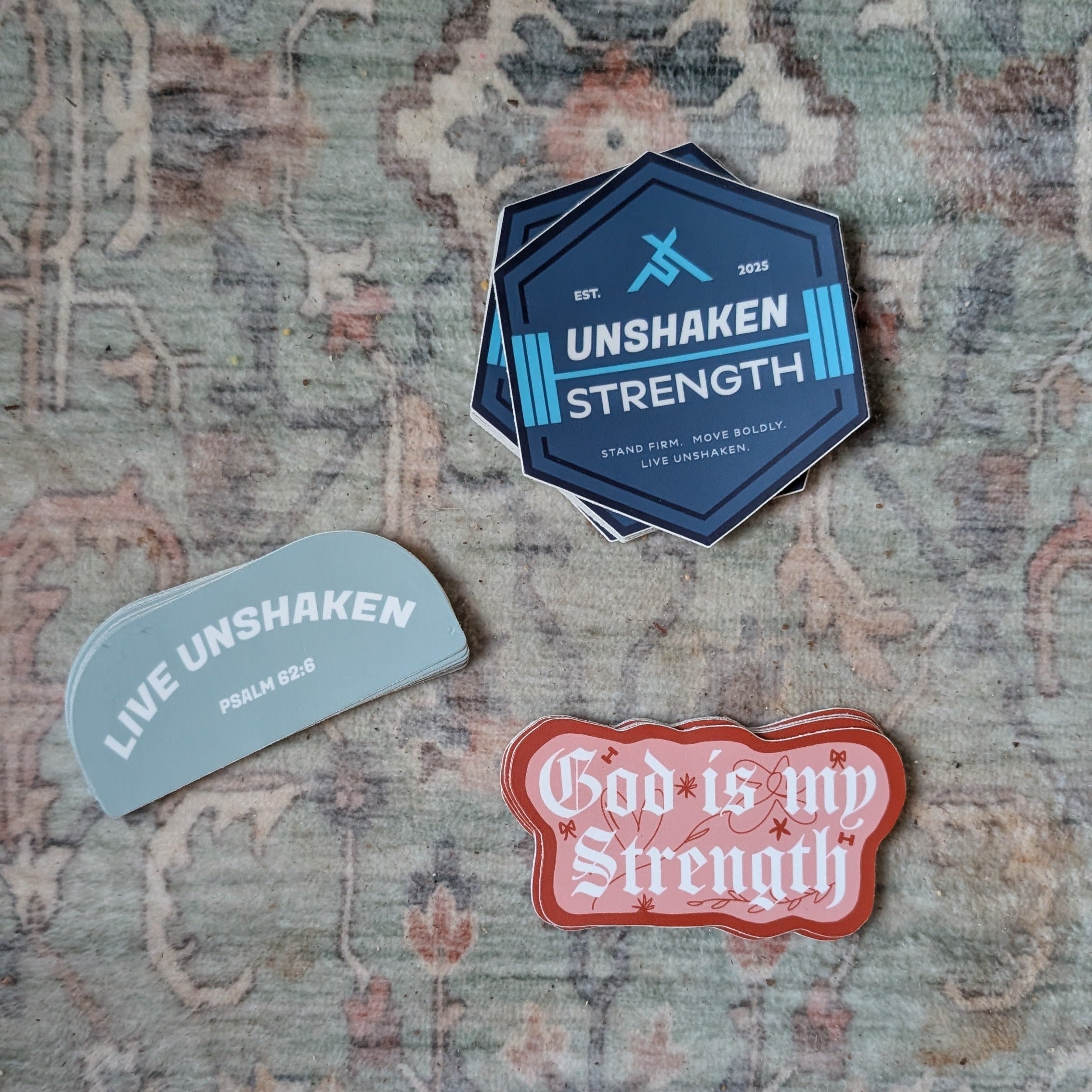 Three motivational stickers on a textured surface